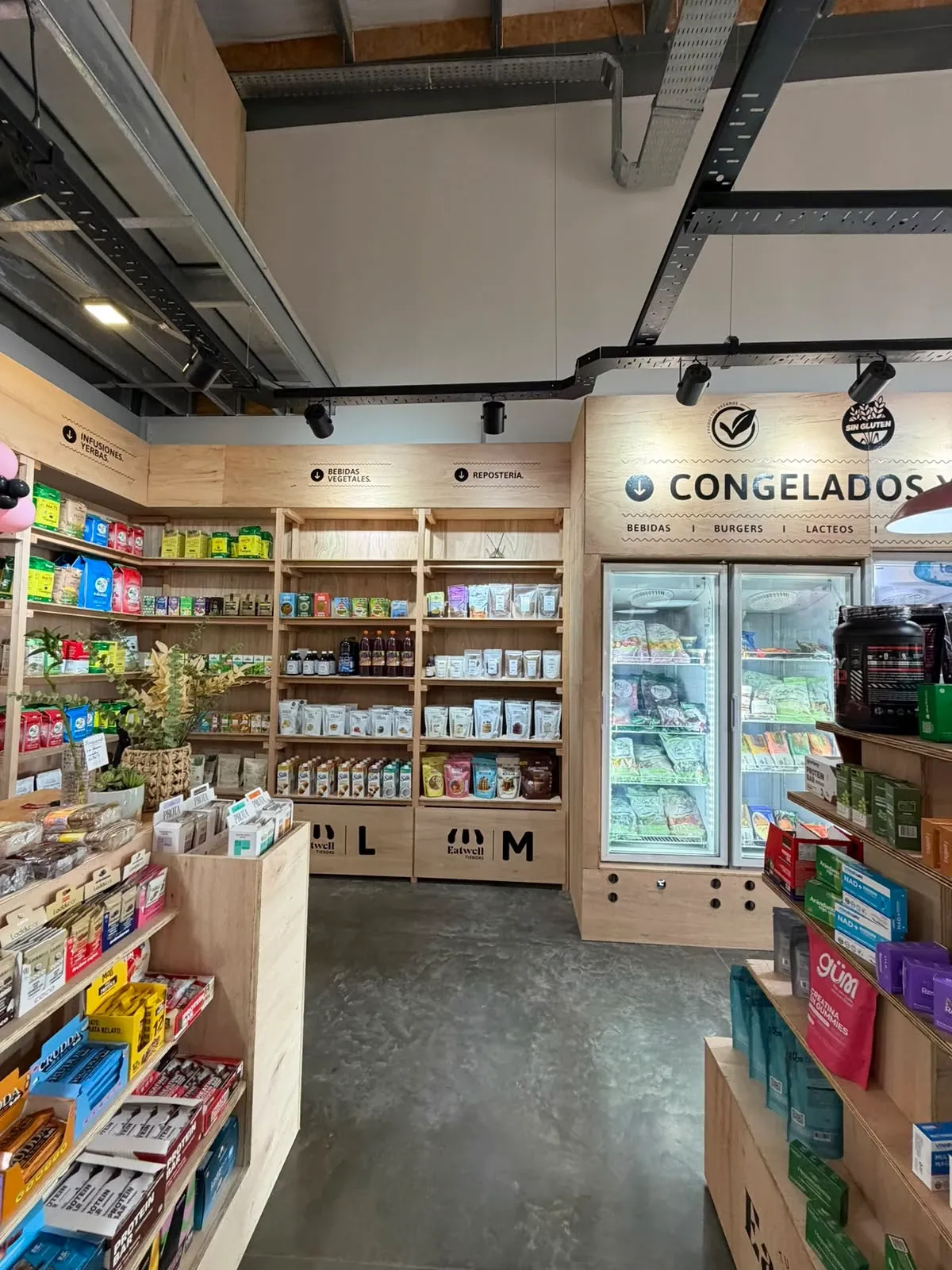 Sector de congelados de la Tienda Eatwell de Santa Fe 2, con heladeras y góndolas de madera.